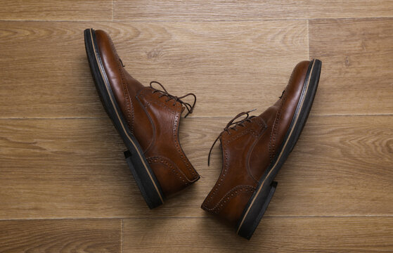 Man's Classic leather brown brogue shoes on floor. Top view