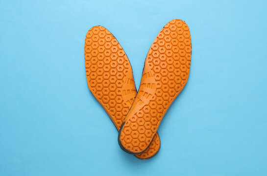 Orthopedic insoles on a blue background