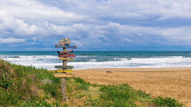 Handmade wooden sign on Is Arenas (or Sas Renas) sandy beach on the western side of Sardinia Island, Italy