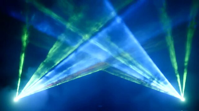 Concert stage with blue and green laser beams.