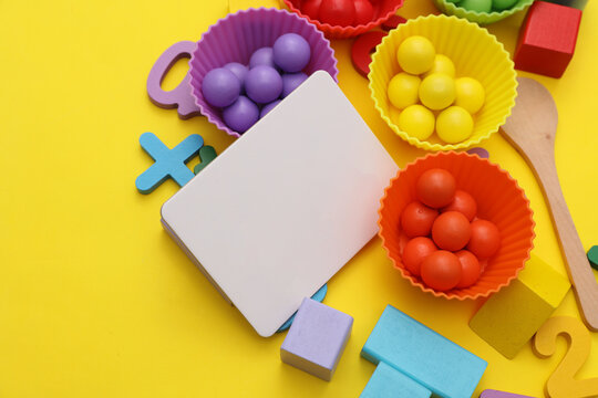 Baby toys for developing motor skills and logic, blank cards on a yellow background