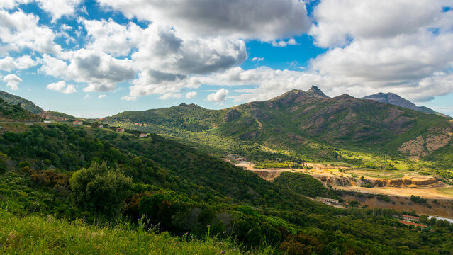 Panoramic view of Montevecchio, abandoned mining village in southwest Sardinia, with lush green hills around it, Italy