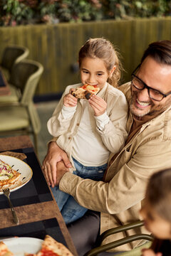 Happy Father And Daughter Sharing Pizza At Outdoor Cafe &mdash; Family Bonding And Casual Dining