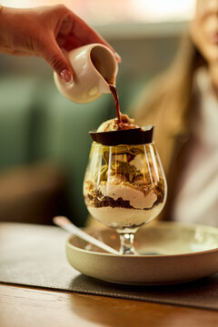 Hand Pouring Espresso Over Ice Cream Affogato Dessert in Glass at Cafe Table, Casual Brunch Moment