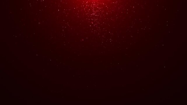 Soft red particle snowfall drifting on dark gradient background, abstract festive motion with glowing dust, depth, and calm atmospheric effect