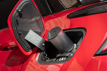 Obraz premium Close up of a vehicle to load apapter plug and socket to enable appliances to be plugged in to electric car Type 2 CCS