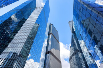 View of modern glass skyscrapers in financial district. Contemporary corporate architecture symbolizing business, finance and urban development.