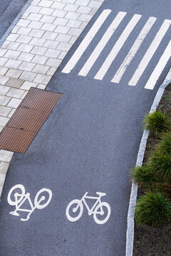 Overhead asphalt in Stockholm Sweden shows bike lane cycling with crosswalk markings as urban safety design guides commuter movement