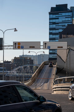 Urban perspective on a road bridge in Stockholm Sweden captures cars in traffic and shows infrastructure supporting the daily commute flow