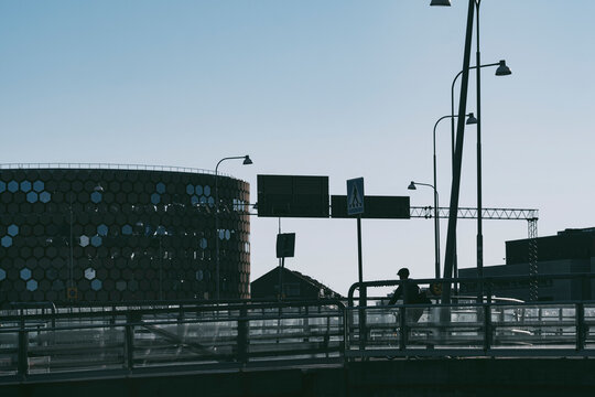 Silhouette cyclist on a bridge frames the skyline in urban Stockholm Sweden linking bicycle mobility and commute across the city span