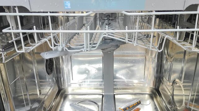 Inside view of a modern dishwasher with empty racks