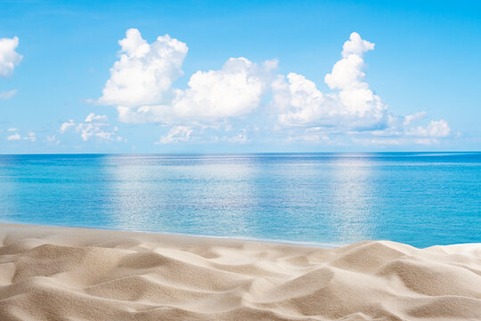 White beach sand and turquoise sea water reflecting clouds as calm beautiful tropical seascape