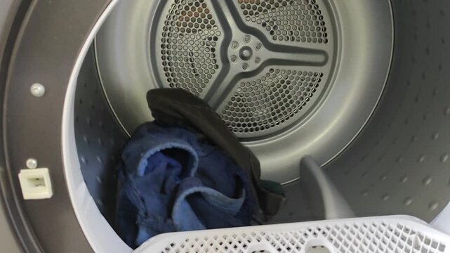 Automatic clothes dryer in operation with spinning inner drum