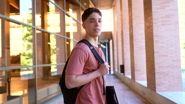 Young male university student smiling on campus