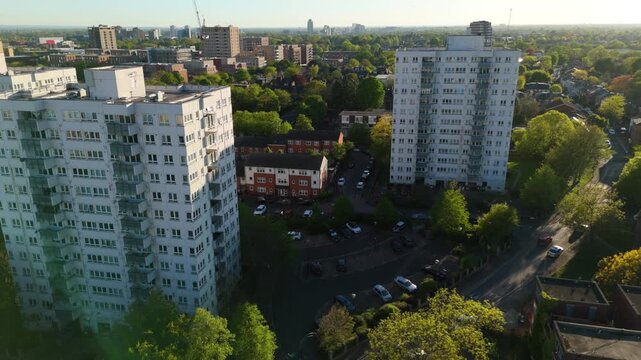 High-rise residential towers and leafy green streets in Acton, West London on summer day