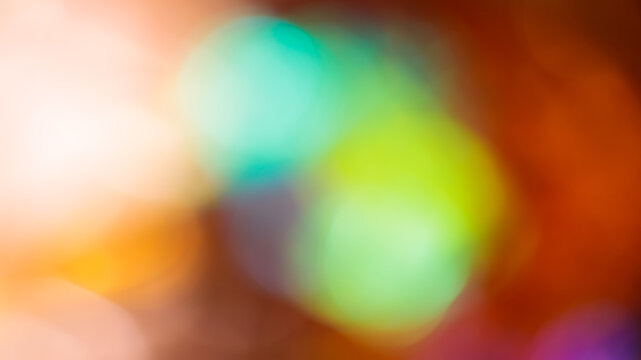 Abstract colorful bokeh light effect with teal and green glowing circles