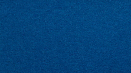 Deep blue paper texture background with fibrous surface for solid color backdrop with copy space © Lazartivan