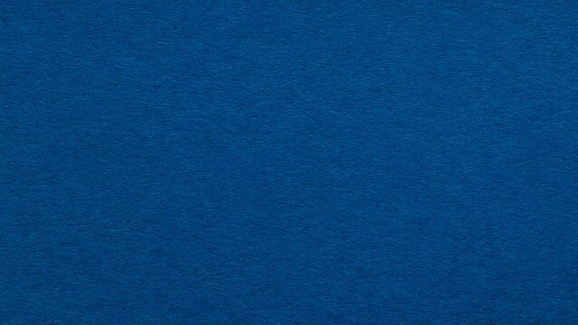 Deep blue paper texture background with fibrous surface for solid color backdrop with copy space