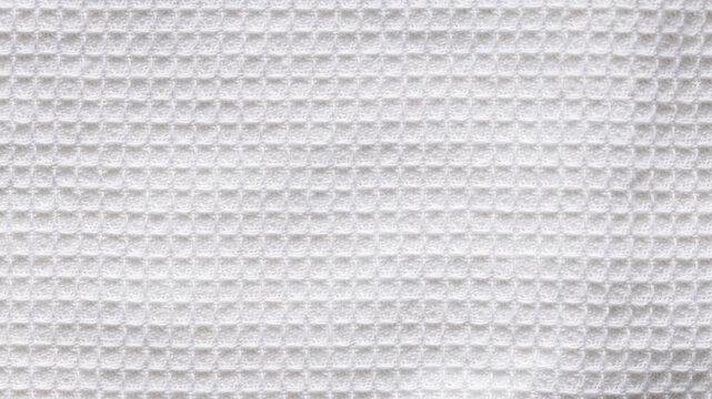 White waffle weave fabric texture with square grid pattern as a clean background close-up