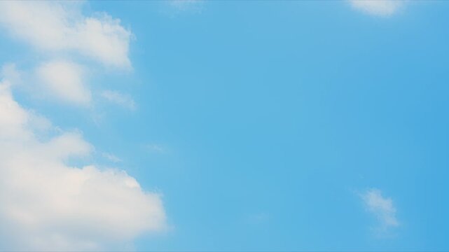 A blue sky timelapse video footage featuring expanding cumulus clouds along the horizon, showcasing soft billowy forms, gradual growth, and gentle atmospheric motion under clear daylight skies. 4k.
