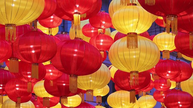 Detailed view of glowing traditional lanterns at Lee Tung Avenue, Hong Kong. Visualizes Spring Festival celebrations, ornate street decorations, and seasonal tourism in a major hub.