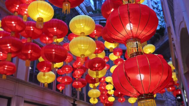Low-angle view of hundreds of traditional lanterns at Lee Tung Avenue, Hong Kong. Visualizes Spring Festival celebrations, ornate city decorations, and seasonal tourism in a major financial hub.