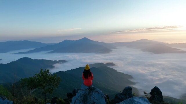 Travelers taking photo on rocks at Doi pha tang, Chiang rai, Thailand.
