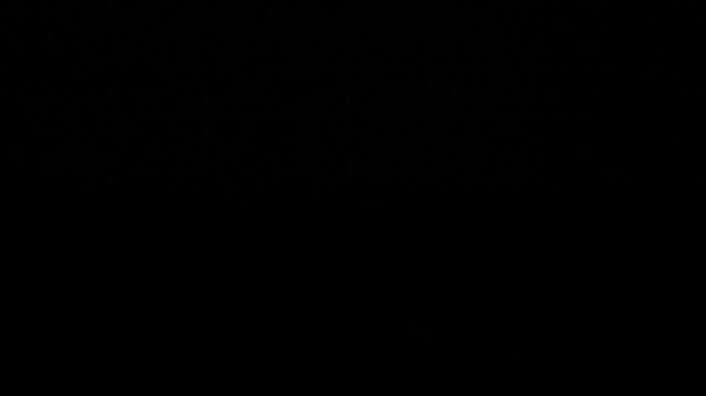 Candle flame lights up a dark room at night