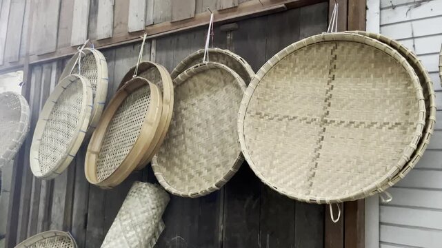 Row of Traditional Bamboo Winnowing Trays Hanging Outdoors