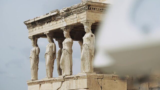 Cinematic view of statues at The Porch of the Caryatids at Erechtheion, Acropolis in Athens, Greece