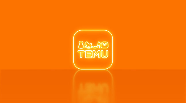 E-commerce app temu logo illuminating an orange studio background. Representing retail, consumerism, and digital marketplace