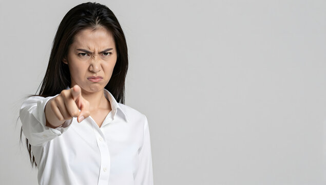 Accusatory Stance: A woman in a white shirt directs a pointed finger, conveying a clear message of disapproval or blame.