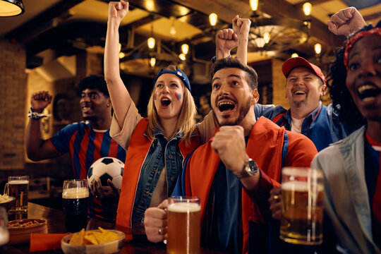 Passionate fans celebrating their team's victory during soccer championship.