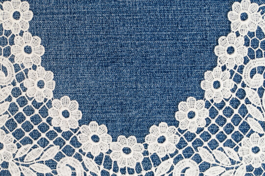 Lace trim on denim fabric shows detailed patterns and textures in a close-up view during daylight hours