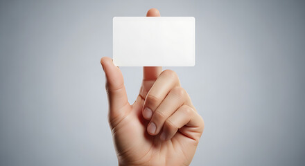 Fototapeta premium Hand holding a blank white business card for design