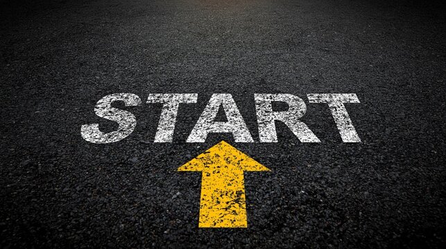 START text with an arrow on a black asphalt road