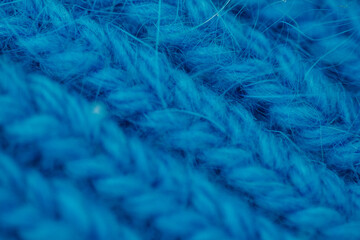 Obraz premium Blue knitted fabric texture close up, soft textile pattern, abstract background, cozy material concept.
