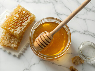 Fototapeta premium Organic raw honey in glass jar with wooden honey dipper and honeycomb on white marble, premium health food photography 4:3 8k 