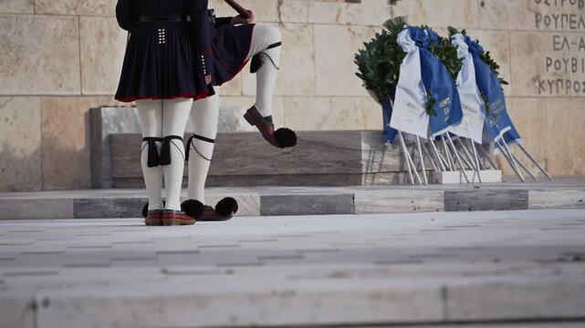 Evzoni guarding the presidential mansion in front of the tomb of the unknown soldier, army infantry in Athens, Greece, slow motion