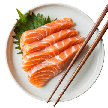 Fresh raw salmon sashimi slices served on a white plate with green shiso leaf and wooden chopsticks