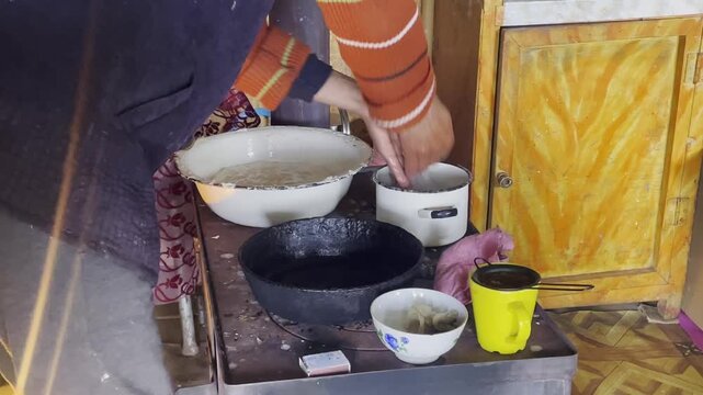 Authentic traditional bread making in Kyrgyzstan: a local kneads white dough in a rustic kitchen, preparing Boorsok or Lepeshka over a traditional stove in a rural mountain home