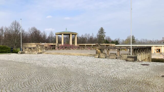 Memorial area in Lidice with stone courtyard and colonnade under calm sky. Historic site in the Czech Republic symbolizing remembrance, loss and quiet reflection in a peaceful setting.