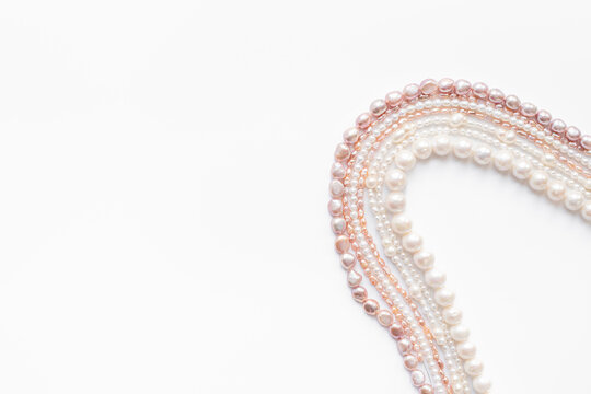 A lot of chains of precious pearls - beads for jewelry, top view. Precious and elegance concept background
