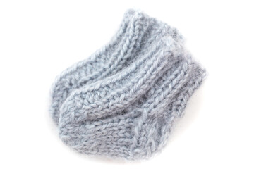 Fototapeta premium Knitted gray baby socks placed on a white background are ready for use in everyday wear