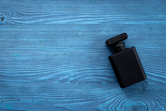 Stylish men perfume in a black bottle top view. Male fragrance and cosmetic concept
