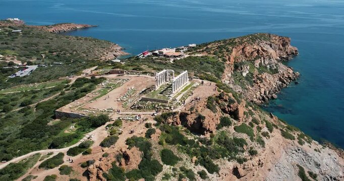 Panoramic view of the Temple of Poseidon at Cape Sounion at the edge of Attica, Greece, aerial drone shot