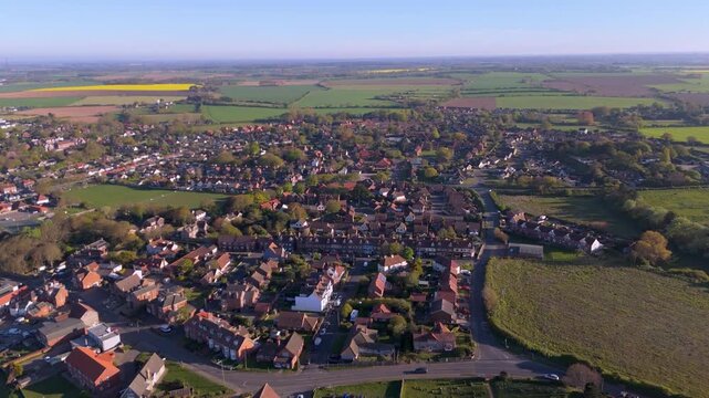 A drone reverse or pullout movement view of the houses in the North Norfolk coastal village of Mundesley in the UK