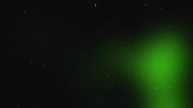 Green Light Leaks with Dust and Scratches on Black Background