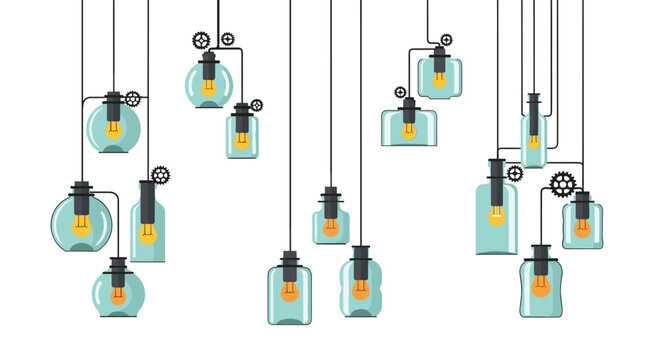 Assortment of vintage Edison light bulbs in unique glass industrial pendant light fixtures hanging at various heights against a white background.
