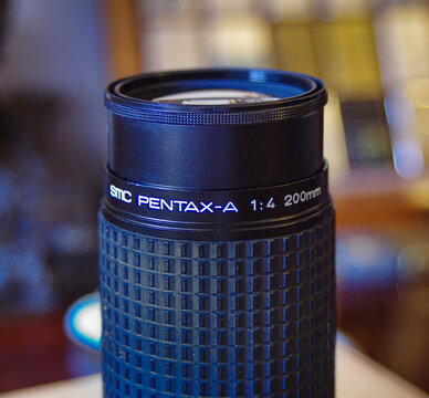 SMC Pentax-A 200mm F/4. A vintage metal camera lens with a rubber focus ring.. Milan - Italy,15 April 2026